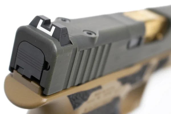 Close-up of the Glock 43X MOS rear sight with white U-notch and distressed ODG slide finish.