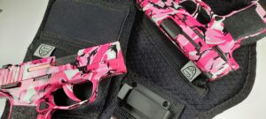 image of Two customized Pink guns in Pink Camo Sig Sauer P365 pistols featured in and around an IWB holster