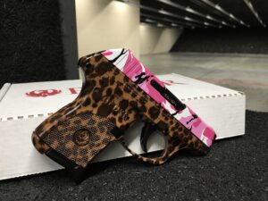 Ruger LCP .380 ACP with customized Cheetah print frame and Pink Camo pattern slide to complete its pink gun finish. Featured in the indoor gun range. 