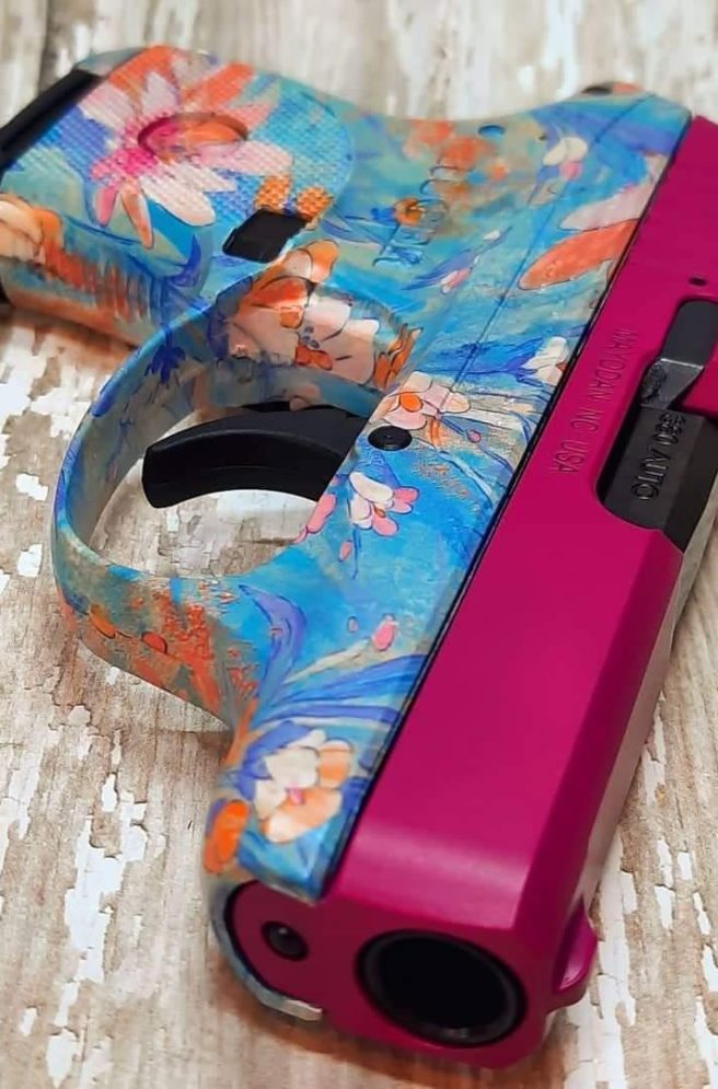 customized pink gun with a ruger lcp pistol in magenta pink paint and hydrographic hydro dipped blue floral pattern